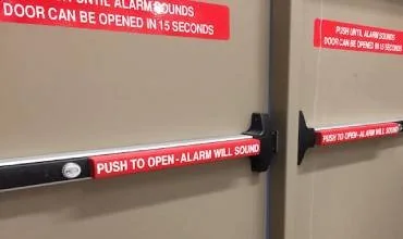 Emergency exit door push-bar hardware